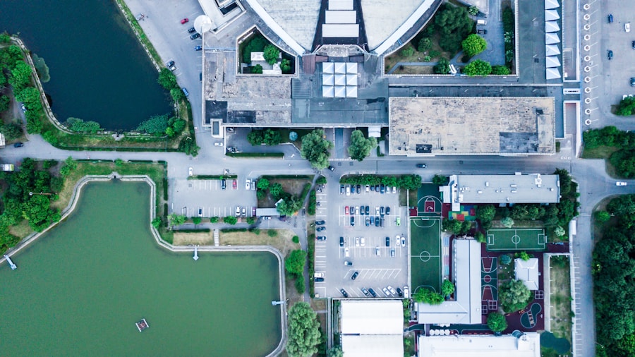 Aerial view of a city with a pond and buildings.