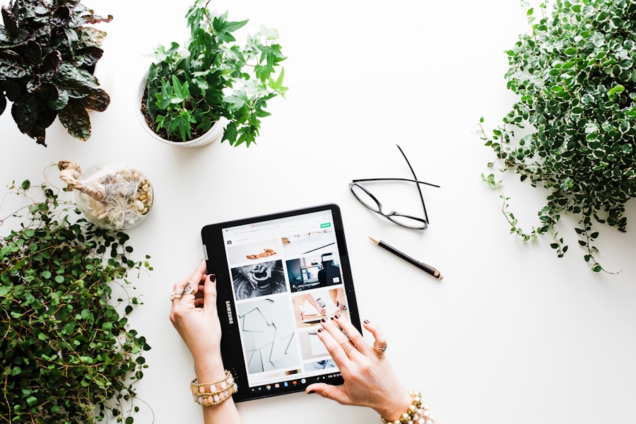 A woman using a tablet surrounded by plants.