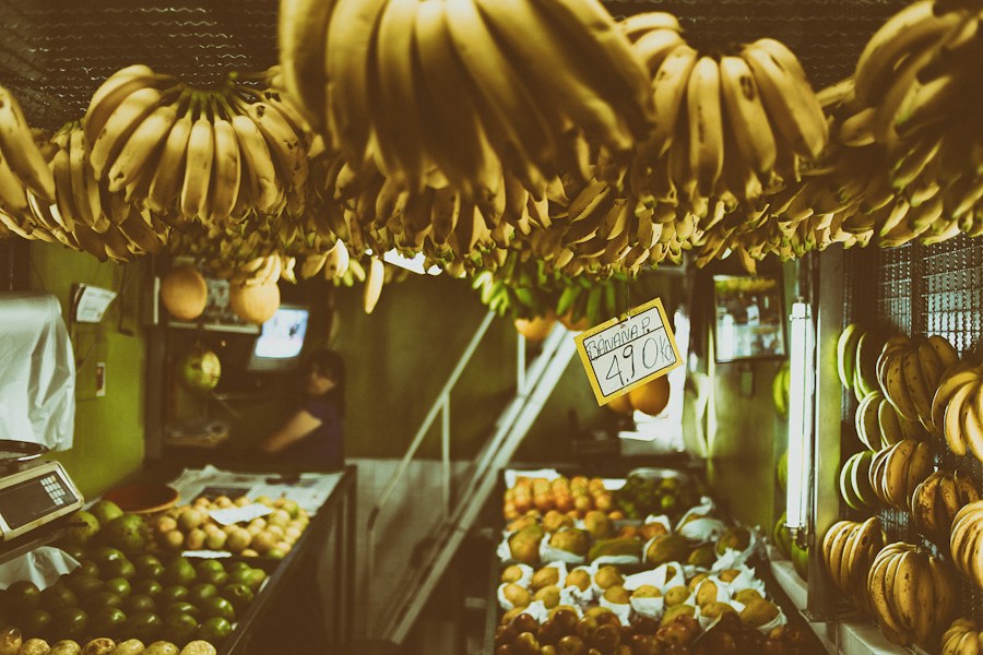 A bunch of bananas hanging from the ceiling.