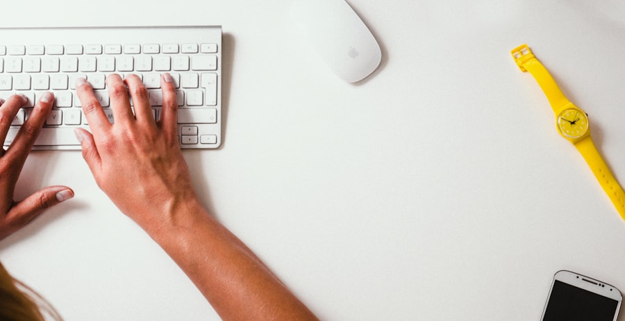 A woman's hands typing on a computer keyboard.