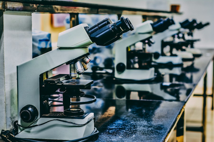 A group of microscopes on a table.