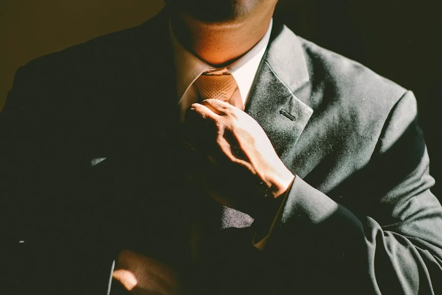 man fixing tie depicting how mind over matter helps overcome obstacles