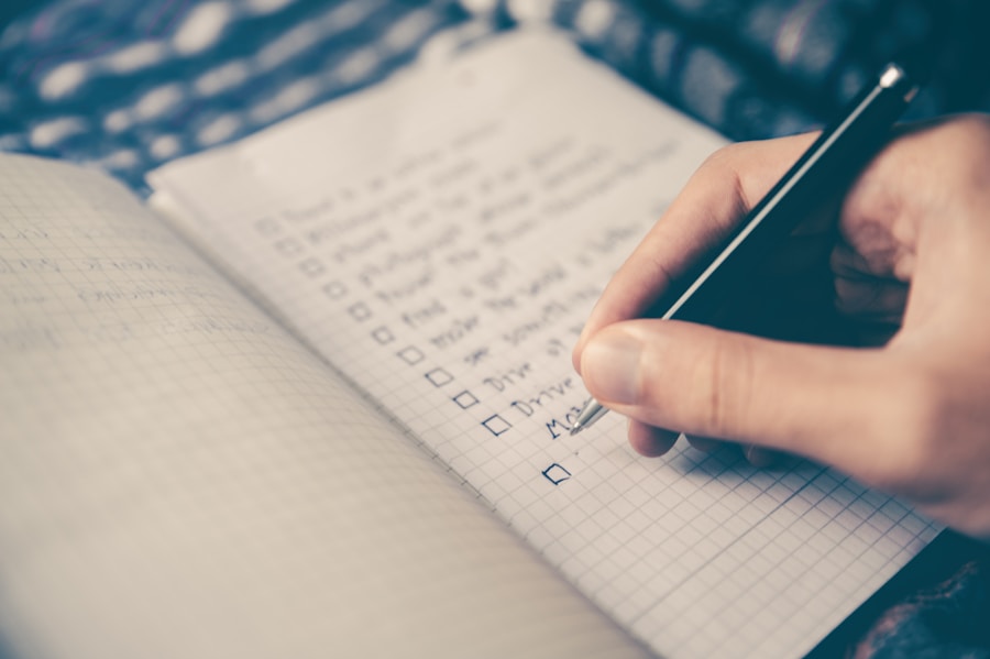 A person writing a to-do list with checkboxes in a notebook.