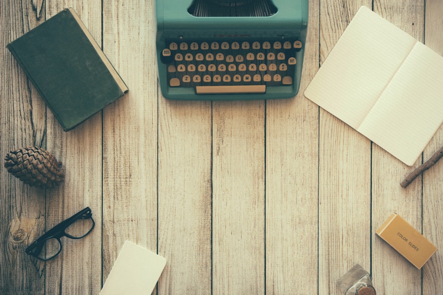 Vintage typewriter and writing essentials on a wooden desk.