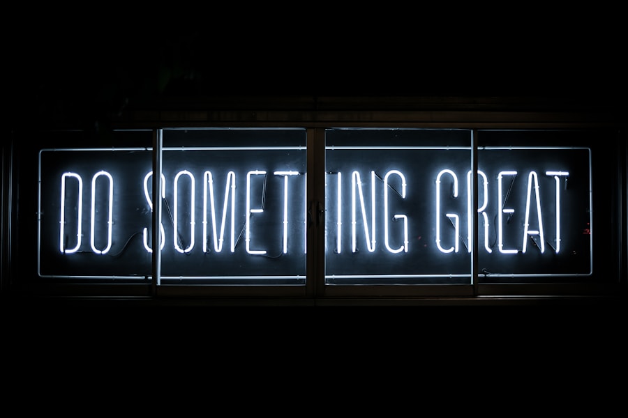 Neon sign with the inspirational message "do something great" against a dark background.