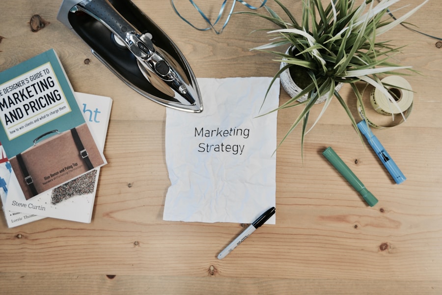 A crumpled piece of paper with "marketing strategy" written on it, surrounded by office supplies and books on a wooden desk depicting affiliate marketing