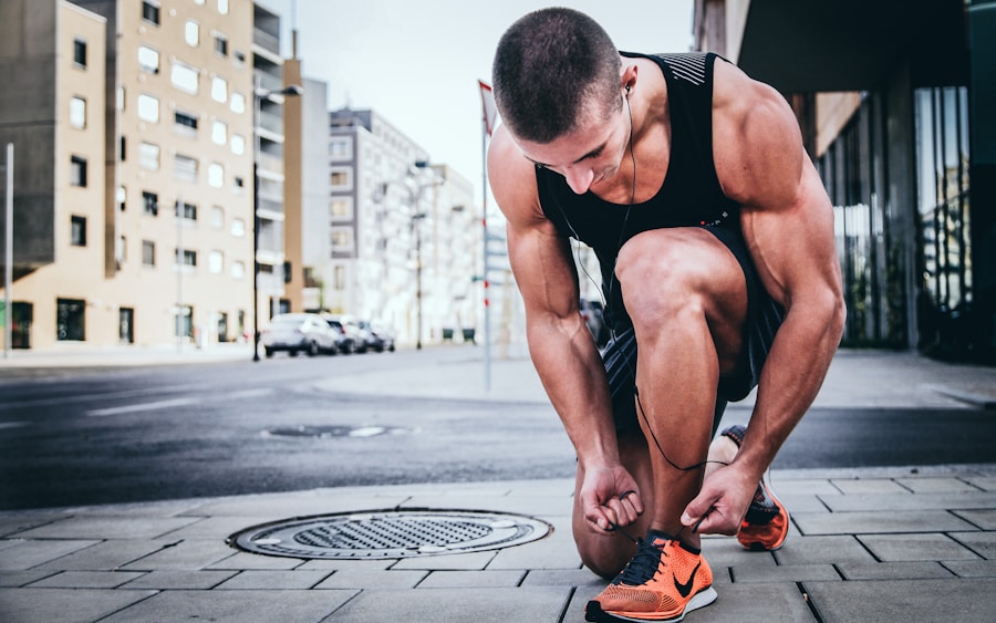 Man tying his shoelaces before a run in an urban environment.