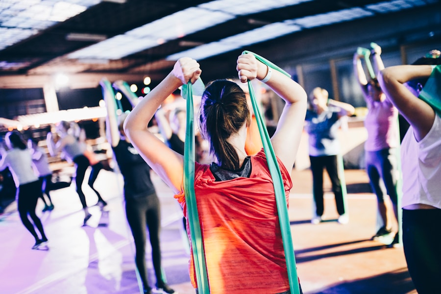 Group fitness class with participants using resistance bands.