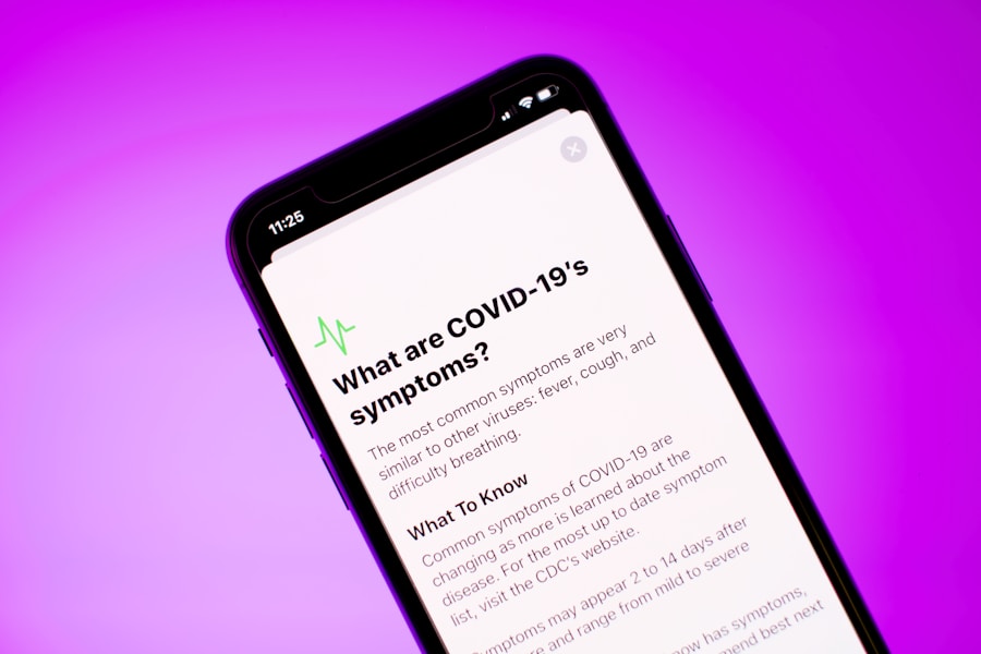 Smartphone displaying information about covid-19 symptoms on a purple background.