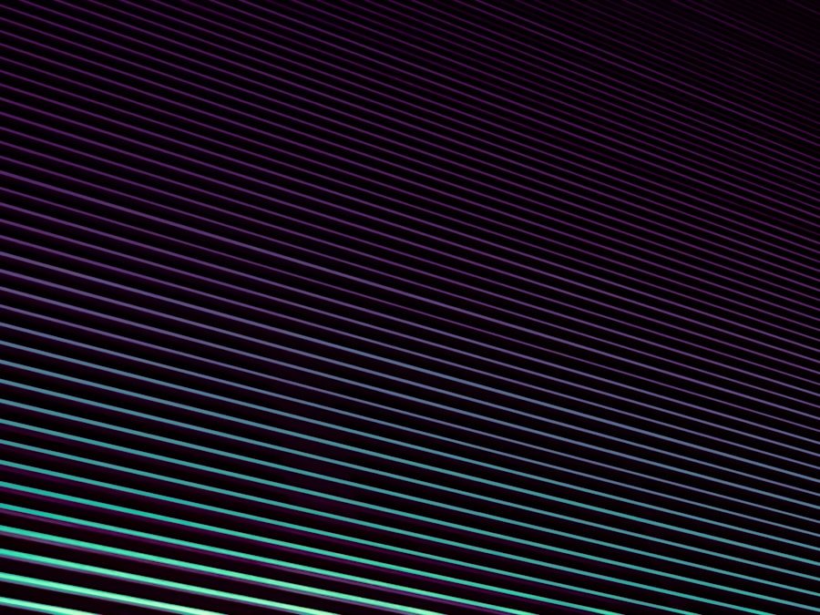 Diagonal stripes in shades of purple and green on a dark background create a geometric abstract pattern.