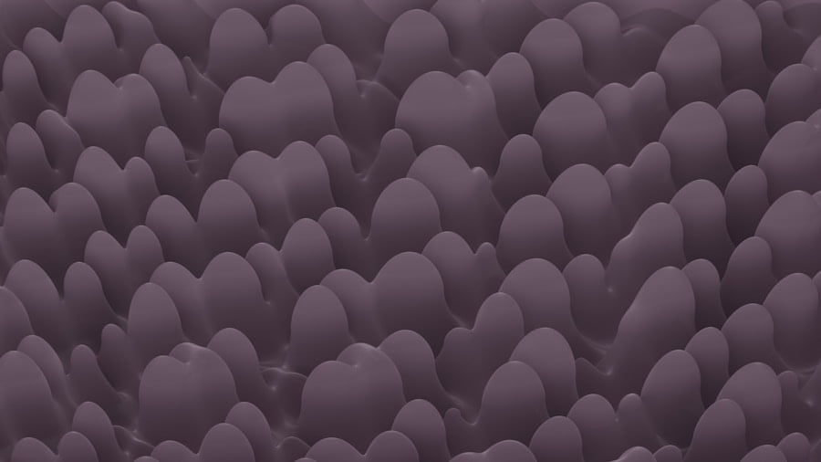 An abstract image featuring many rounded, smooth, and dark purple shapes closely packed together, resembling a field of undulating waves or hills.